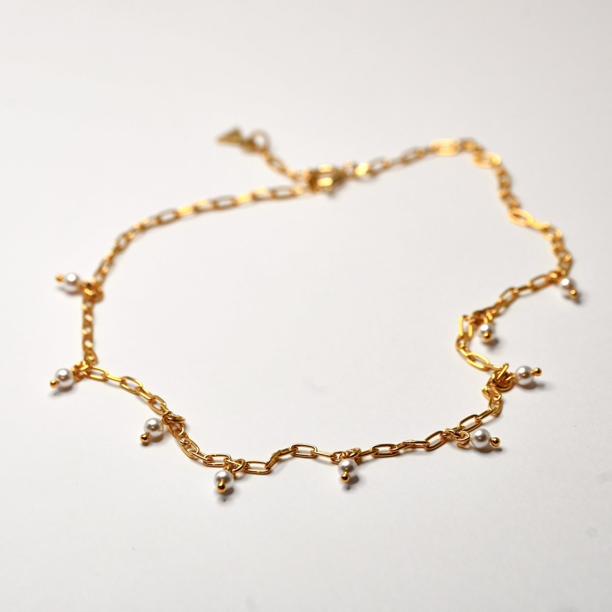 Ancient Pearl necklace - chain with pearls choker on white surface