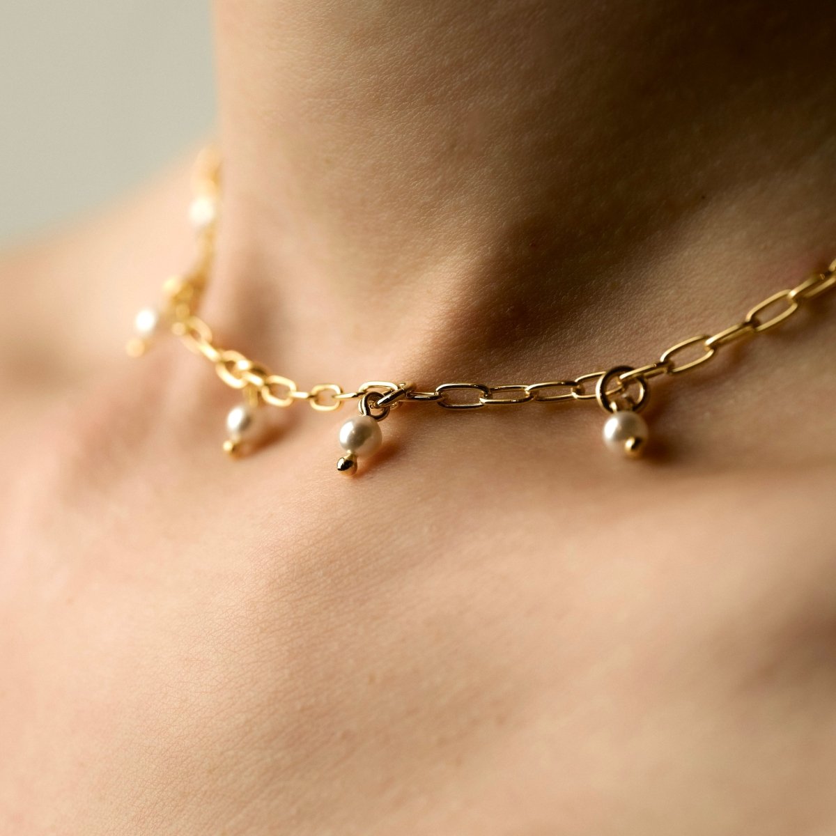 Model wearing Ancient Pearl necklace - close-up of dainty chain-choker with tiny pearls