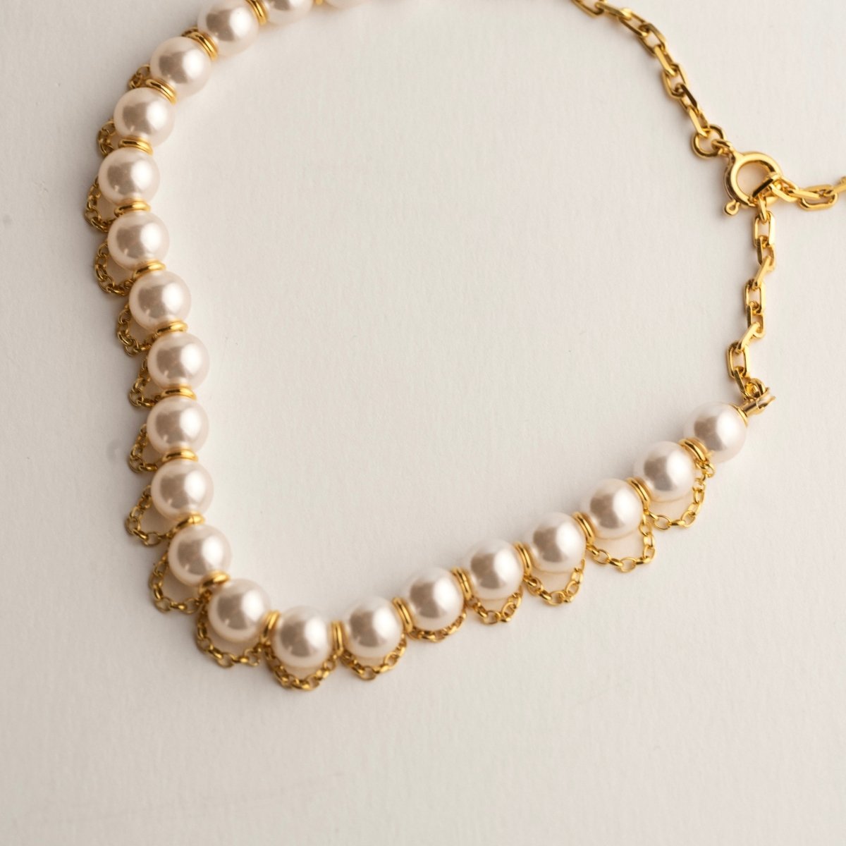 Pearl Net choker lying flat on a white surface with lobster clasp visible