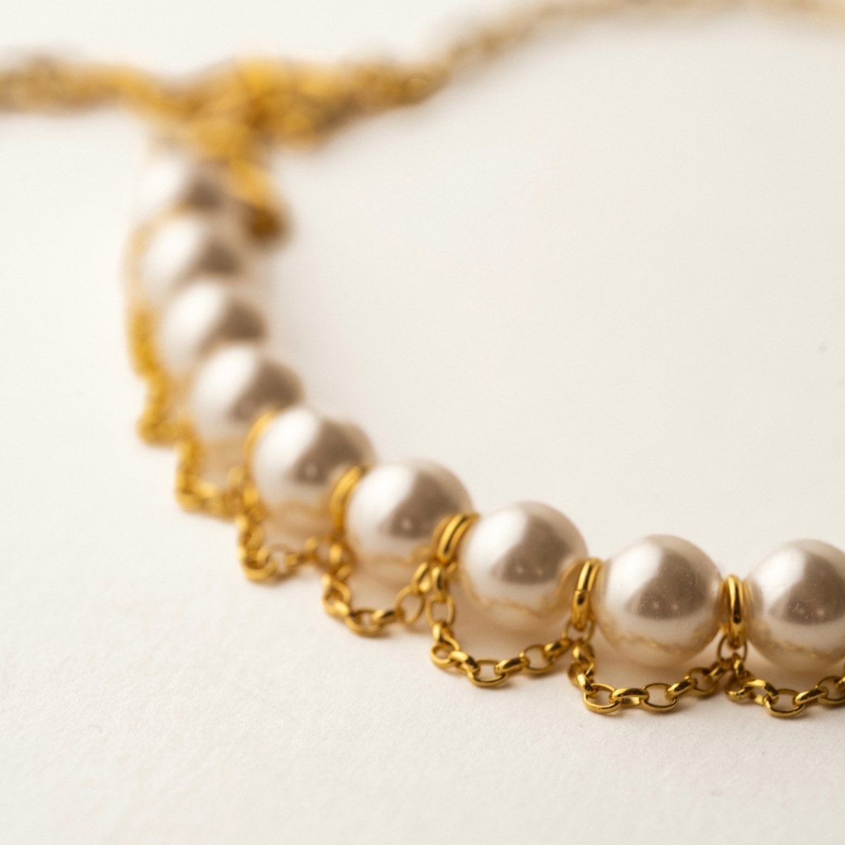Pearl Net choker - focus on pearls, with the rest of the necklace blurred in the background