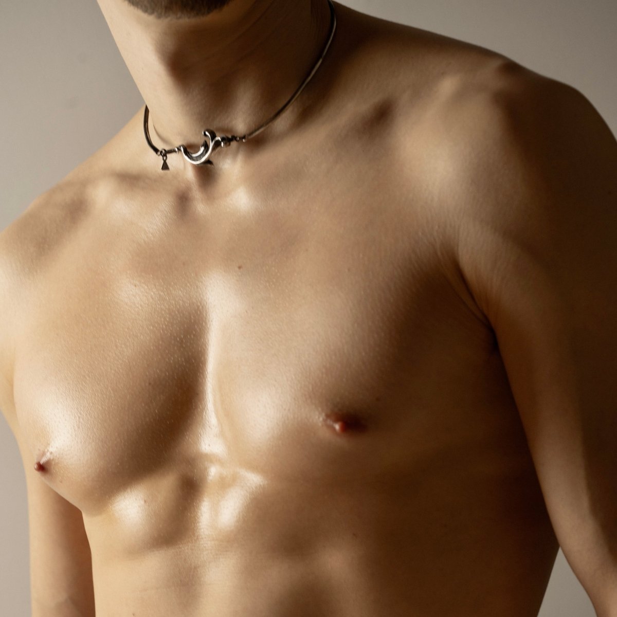 Male model wearing Rocaille necklace - cuff choker with curled silver ornament