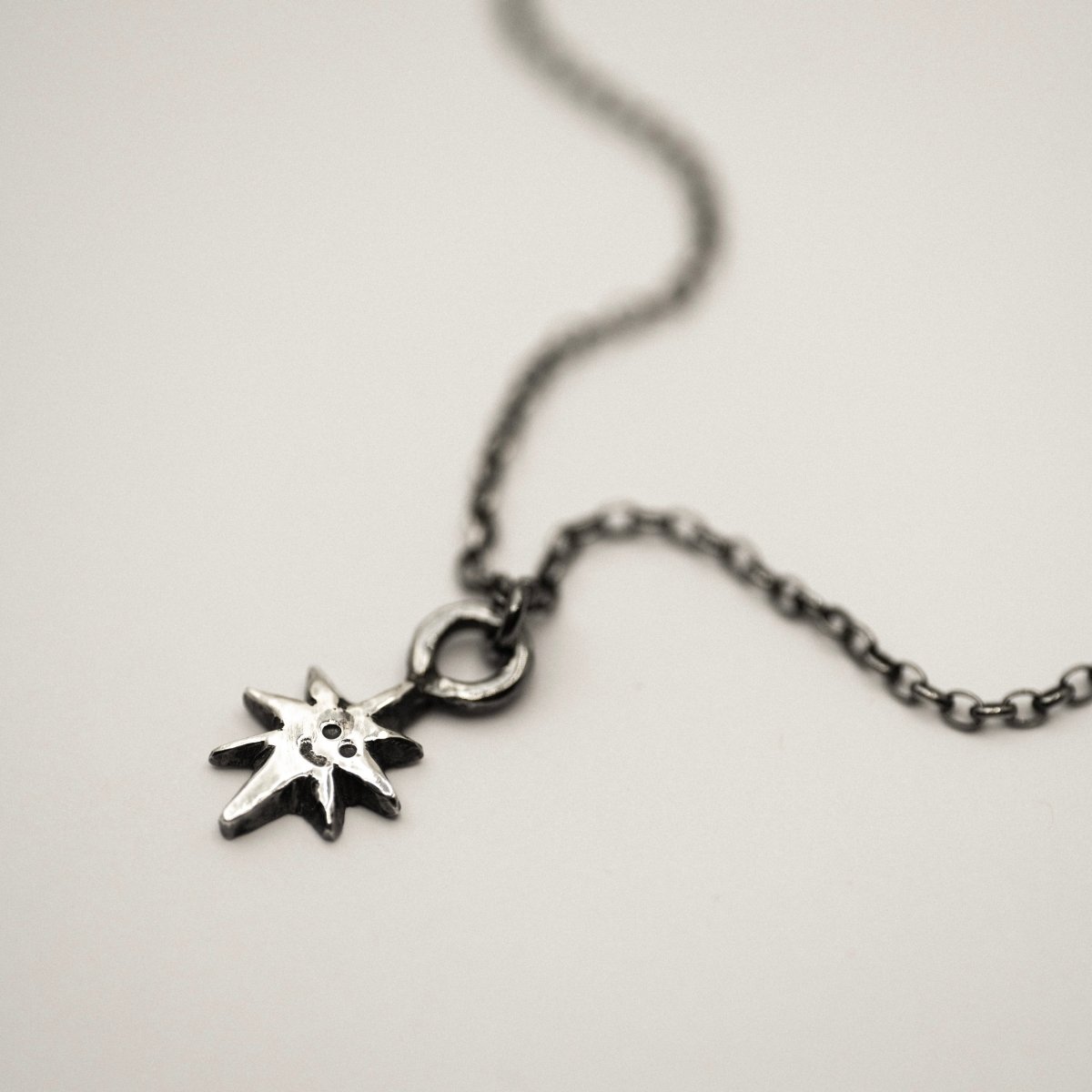 Smiling Star mini pendant by Macabre Gadgets - dainty kawaii accessory on neutral surface