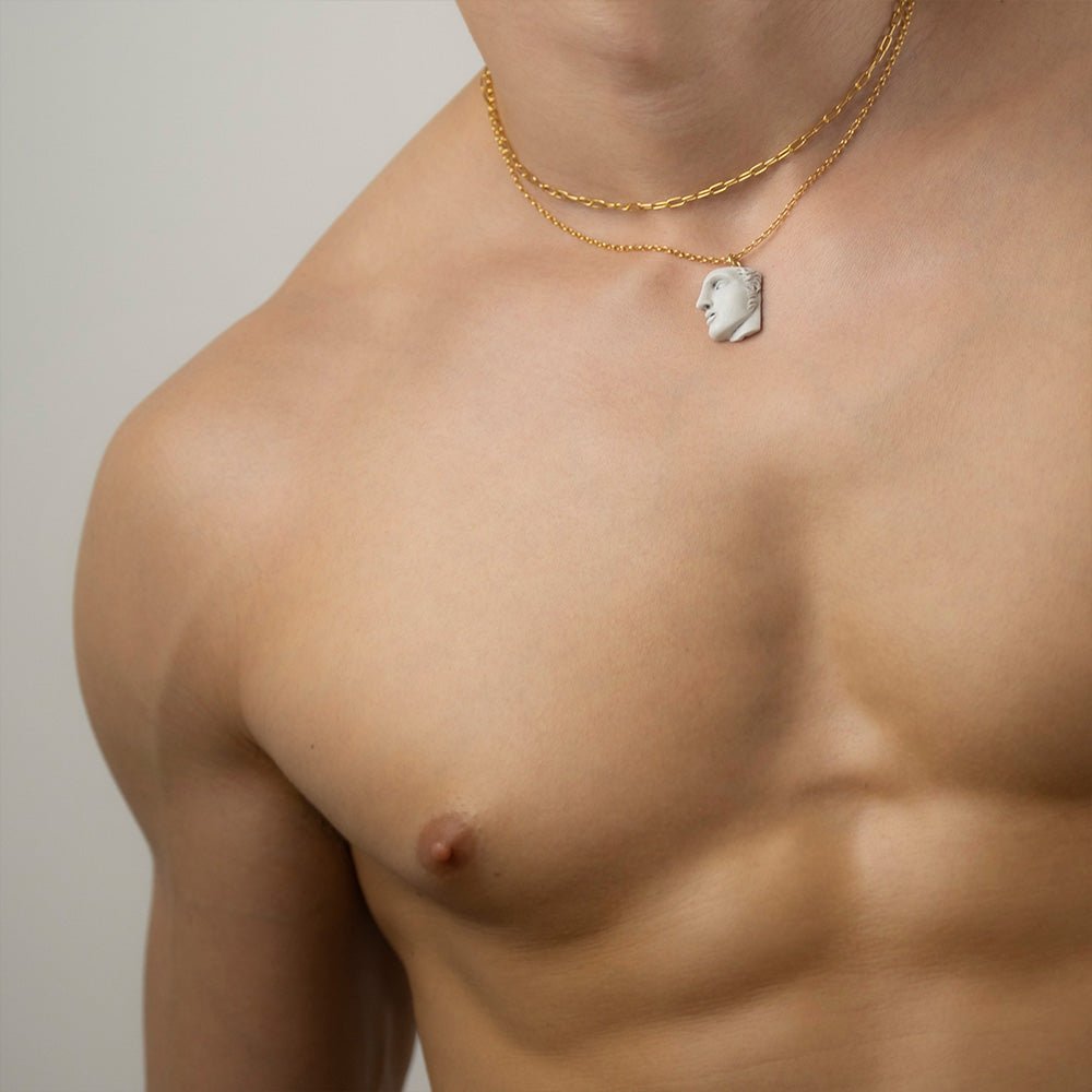 Achiles pendant - gold variant - on a male model, mythology jewelry styling shot