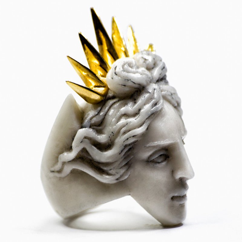Close-up of Apollo ring - greek god inspired sculptured ring featuring Apollo head in gold-plated crown on white background