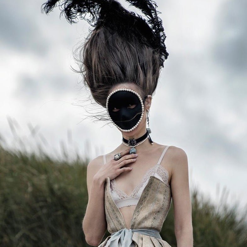 Black Lyre choker in Macabre Gadgets "Ghost" campaign featuring female model in tall powder wig wearing a number of chokers and rings
