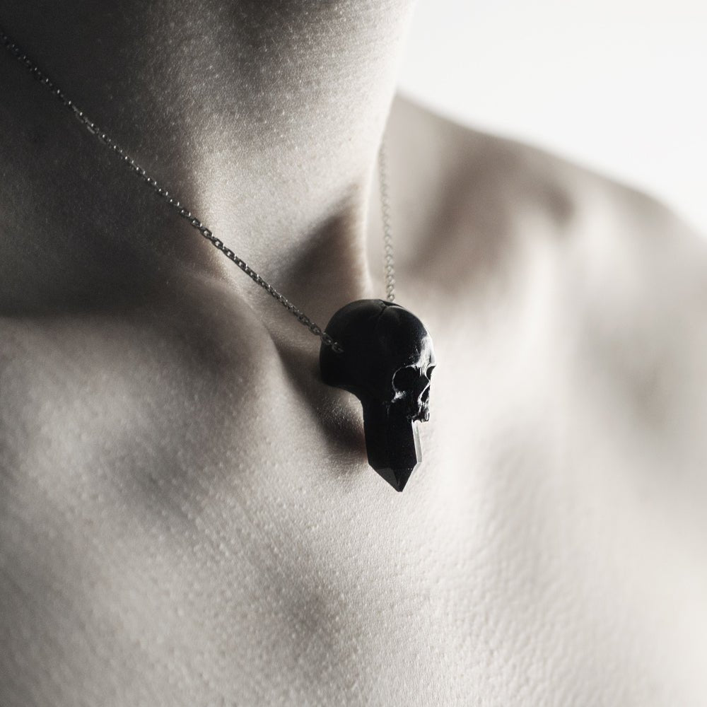 Close-up of Crystal Skull pendant on model's neck - gothic skull and crystal pendant styling shot