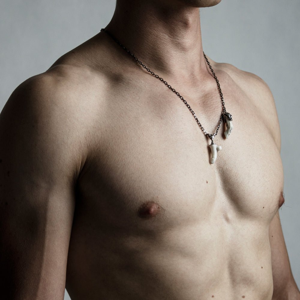 Male model wearing Faun pendant - two charms necklace with fertility symbol