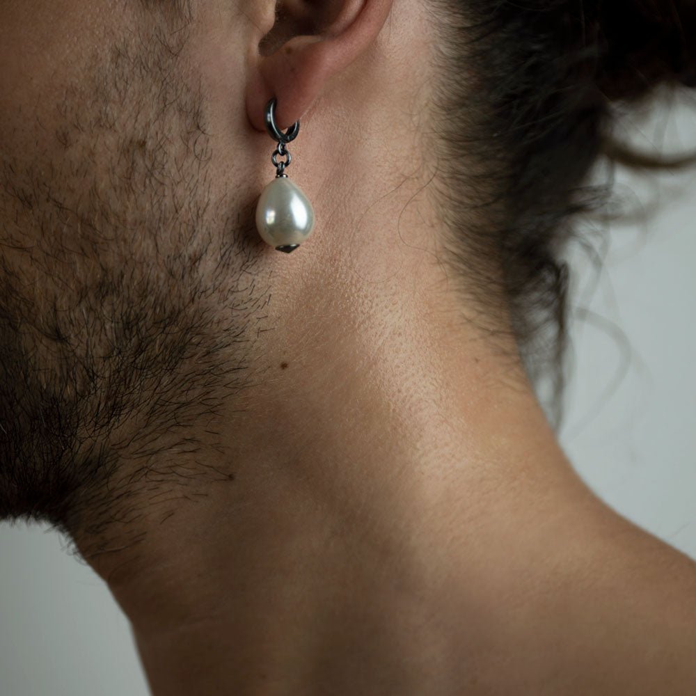 Large pearl earring - close up on a male model with beard
