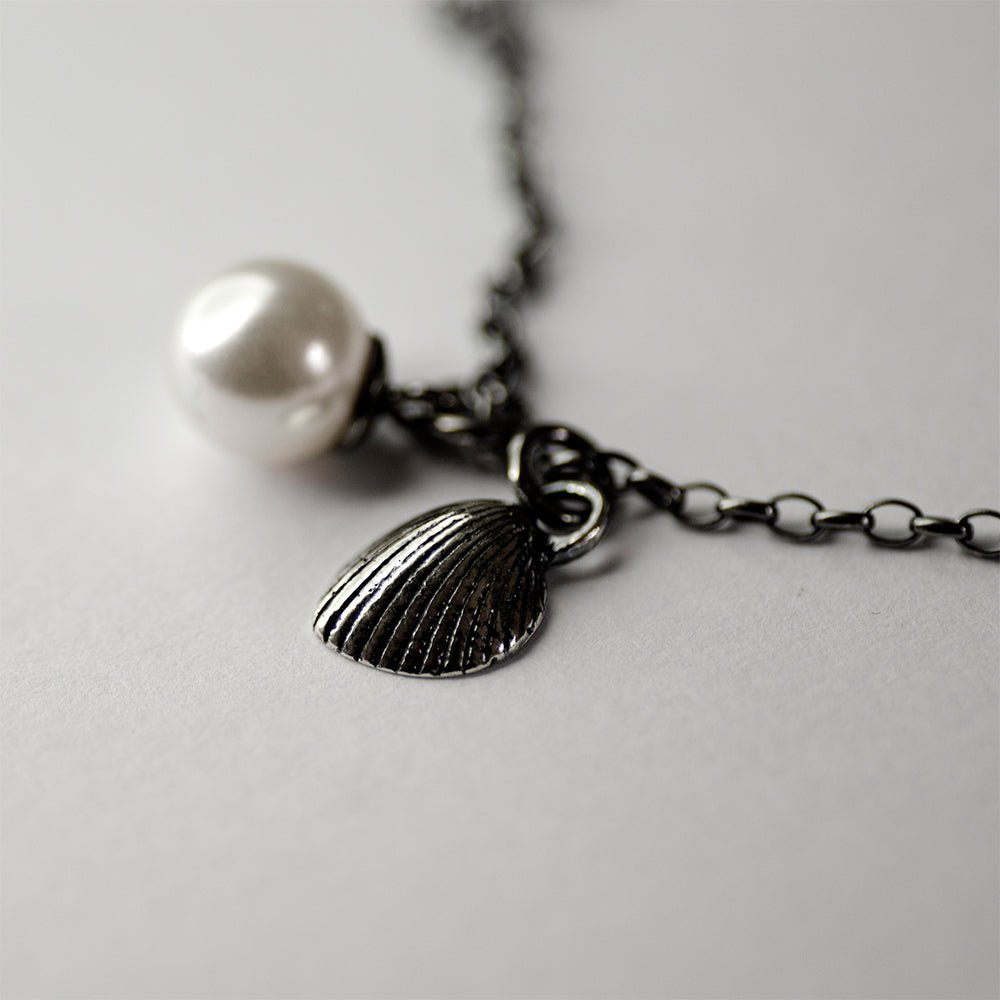 Shell & Pearl pendant - siren core casual chain with charms on neutral surface
