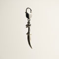 Griffin charm - sterling silver dagger-shaped charm on a white background