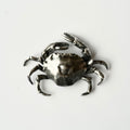 Solid sterling silver crab-shaped brooch hand crafted by Macabre Gadgets on a white background