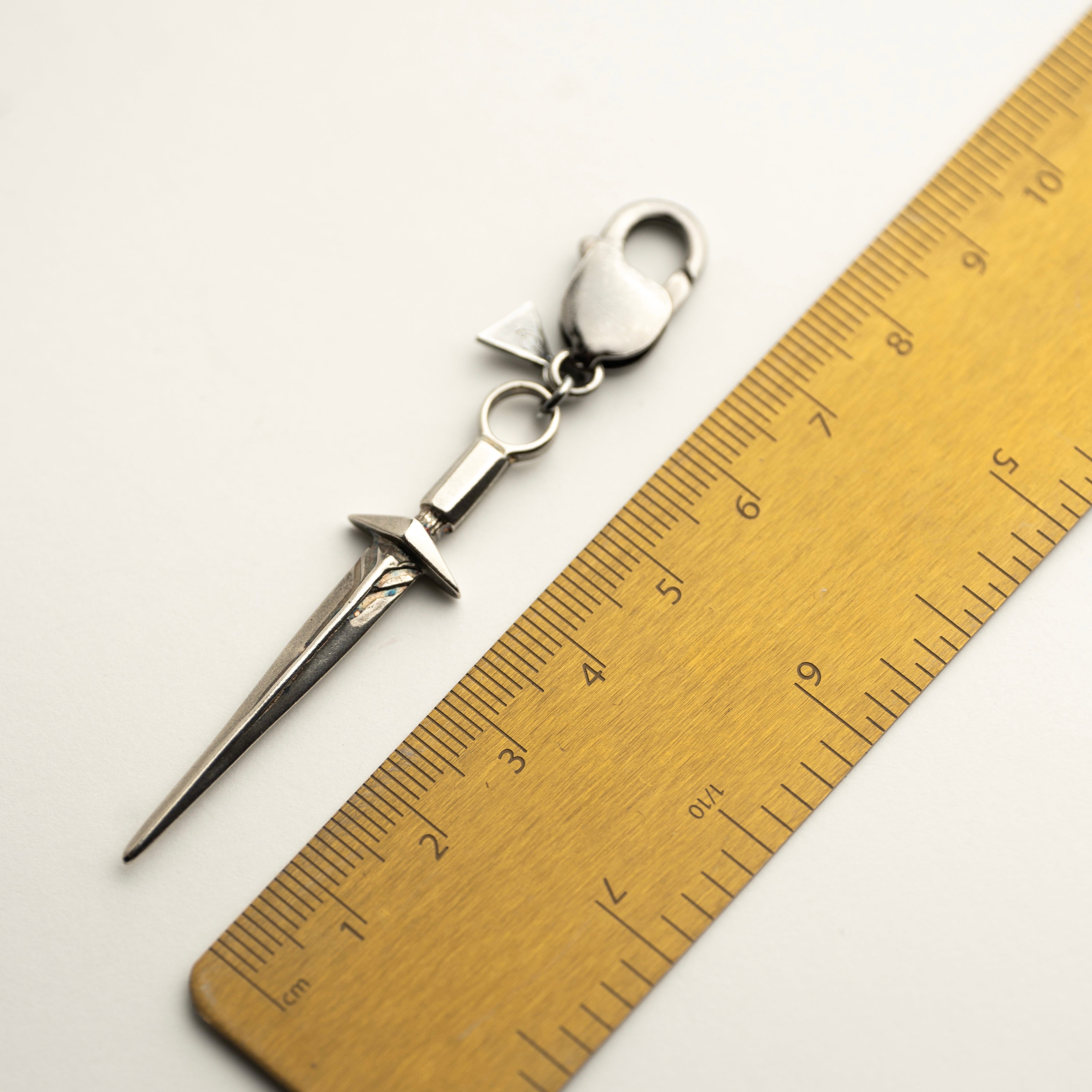 Sword pendant by Macabre Gadgets - sterling silver miniature of a medieval sword - keychain charm on a lobster lock - comparison shot with a ruler
