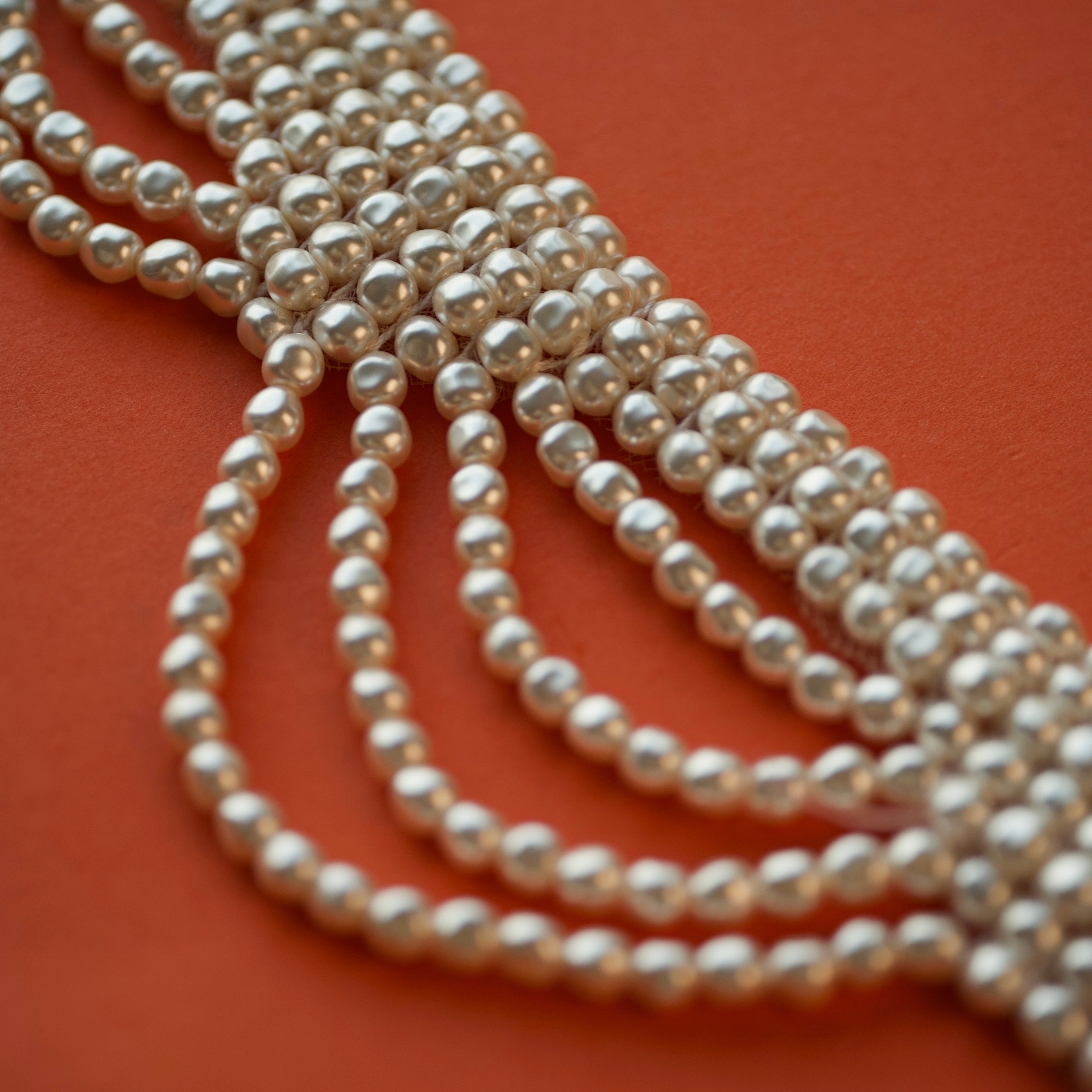 Multi strands Pearl necklace on an terracotta background