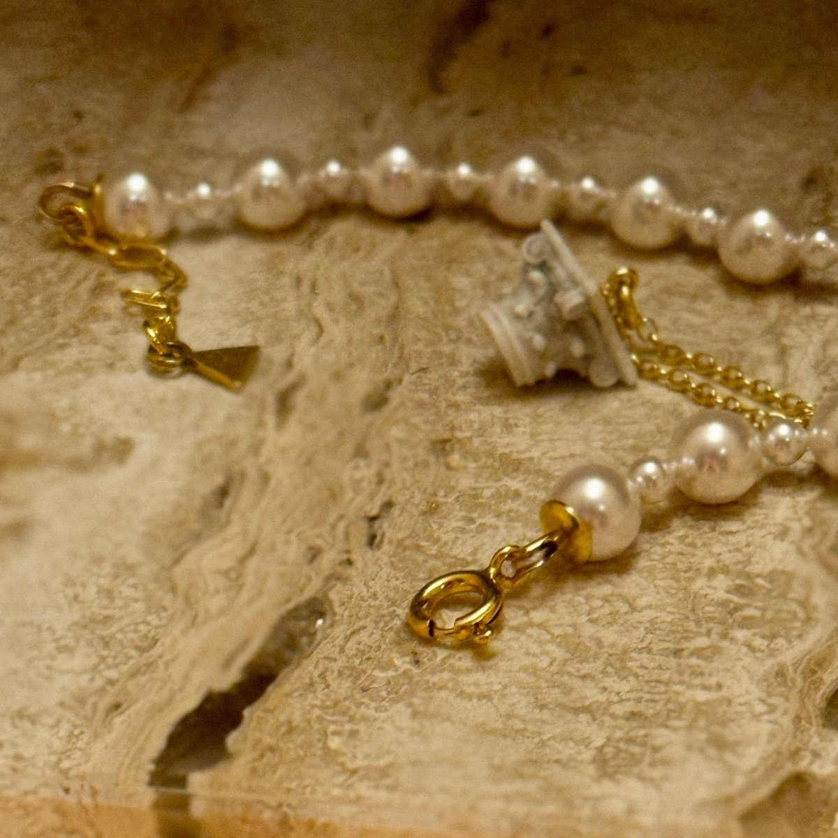 Aegean Pearl choker on a marble surface with Corinth pendant by Macabre Gadgets