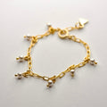 Ancient pearl bracelet - gold variant - placed on a white surface, pearls and chains are clearly visible