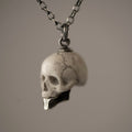 Ancient Skull pendant - white variant - semi-profile view, focus on skull's details and fixture to the chain