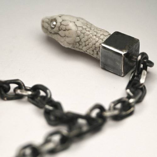 Aspis Snake necklace - white variant - close up of the marble snake, bezel setting and anchor chain