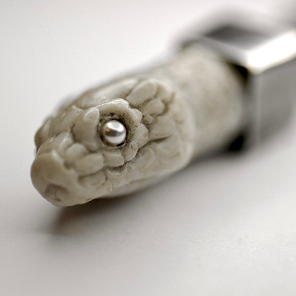 Aspis pendant white variant - close up on pearl eye