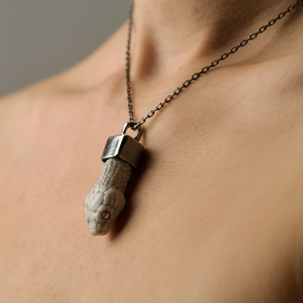 Aspis pendant - white variant with white pearls eyes on a model