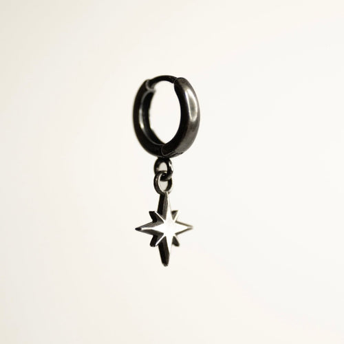 Asteria Small Star earring against white background, tiny star detail and huggie are visible