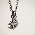 Asteria Small Silver Star and Moon pendant hand crafted by Macabre Gadgets against white background, chain and fixture visible