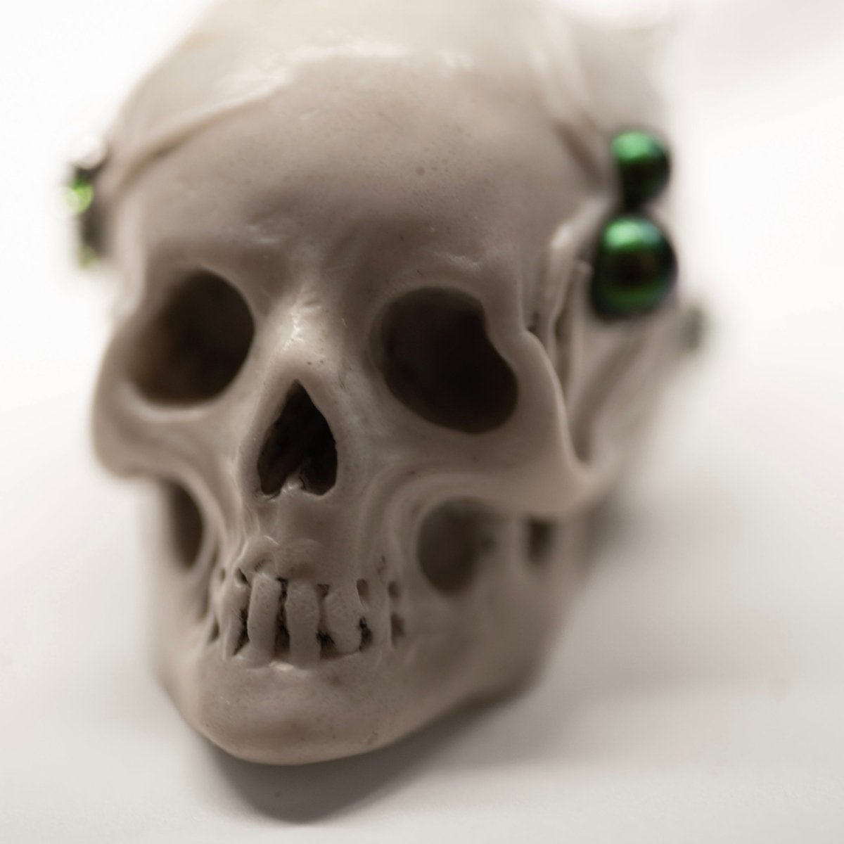 Beetles Skull pendant — white marble variant — close up of netsuke-inspired skull face with expressive decorative features