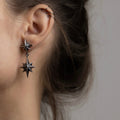 Female model wearing Castor & Pollux earring silver variant, handcrafted celestial sterling silver jewelry