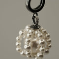 Pearl Cloud earring close-up showing sterling silver huggie clasp and glass pearl cloud design