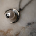 Crescent Moon Pendant close-up — sterling silver crescent cradling luminous glass pearl, handcrafted celestial jewelry