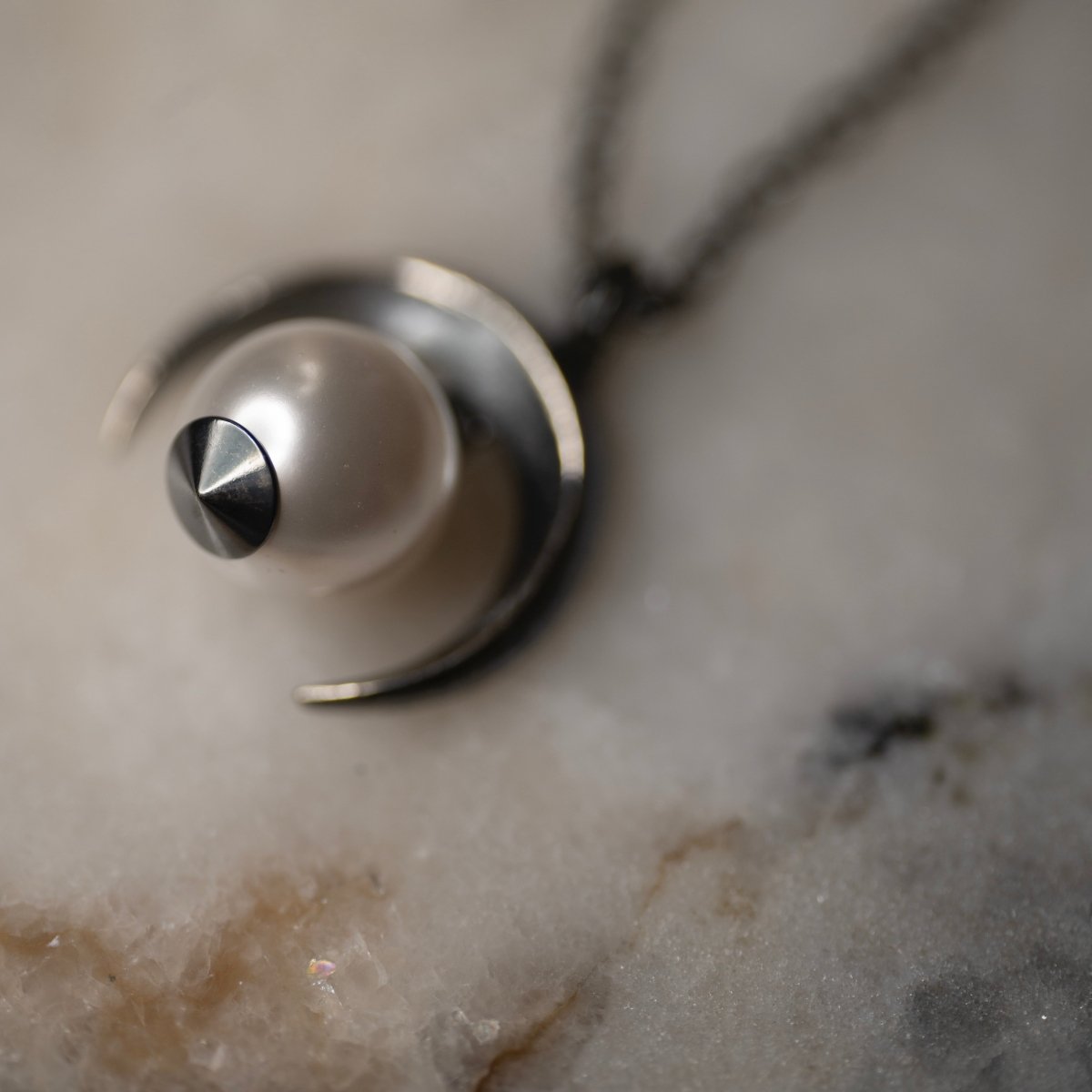 Crescent Moon Pendant close-up — sterling silver crescent cradling luminous glass pearl, handcrafted celestial jewelry