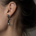 Female model wearing Dusk earring close-up, celestial star and moon jewelry lifestyle shot