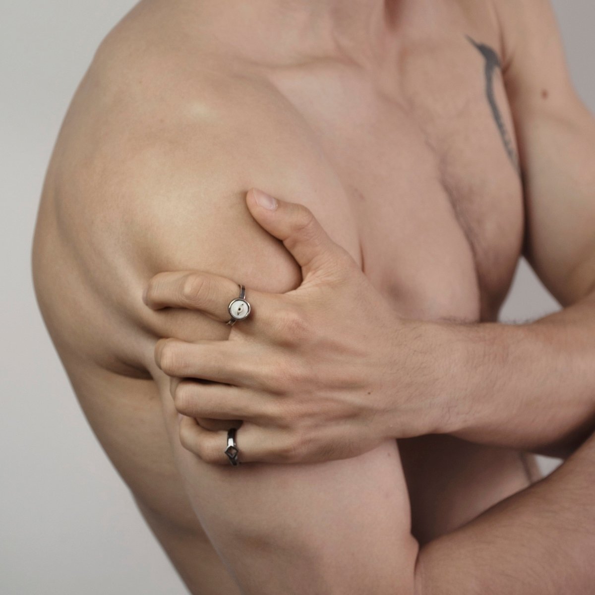 Eye ring and Gothic Clover Ring on a male model, fashion editorial