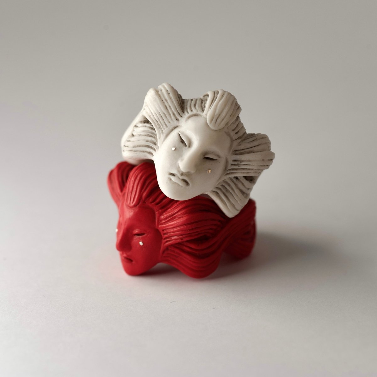 Ghost ring - red and white variants - one on top of another, features are clearly visible, lifestyle editorial