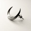 Luna earring - crescent moon earring on neutral surface showing stud lock mechanism, gothic jewelry detail