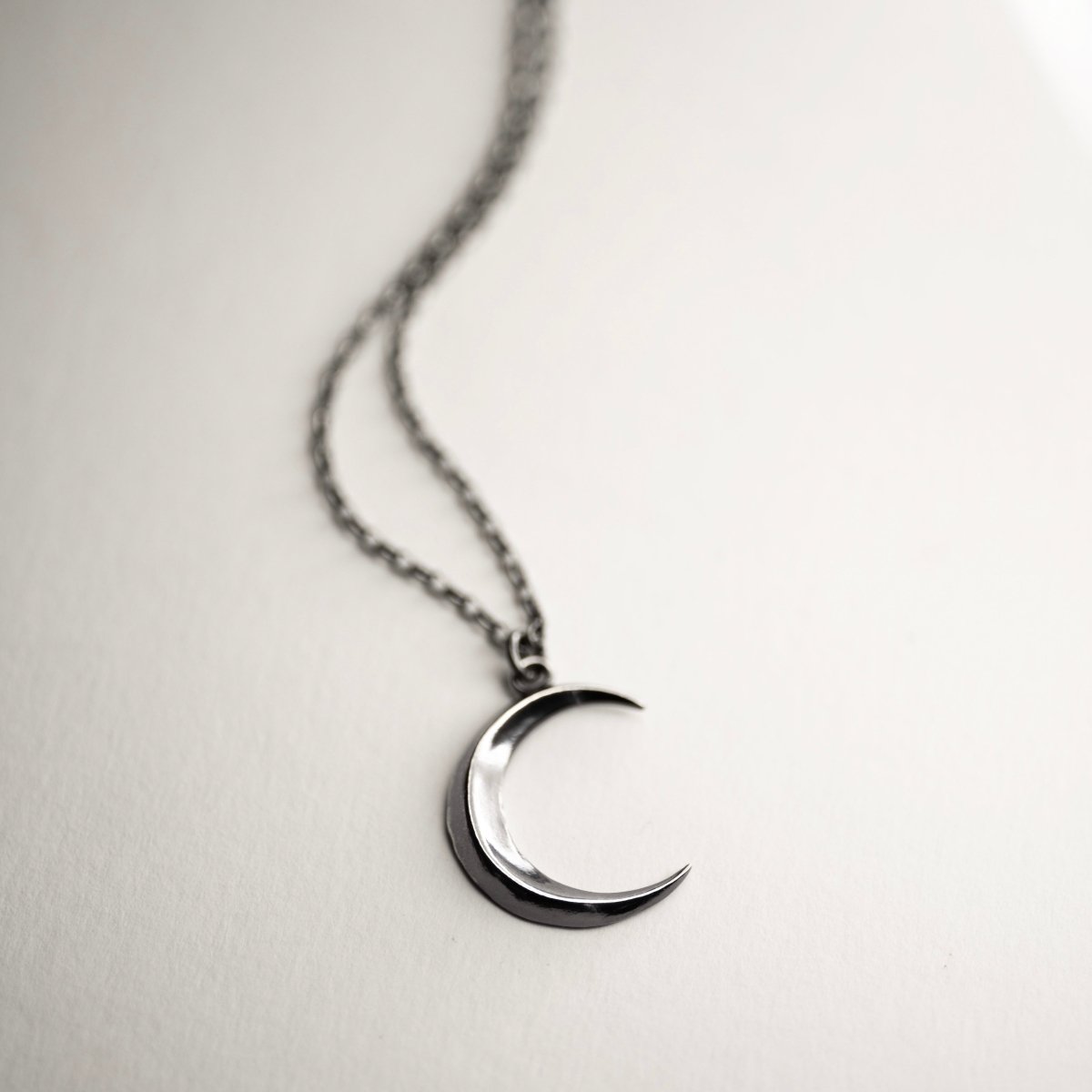 Luna pendant placed on a white surface