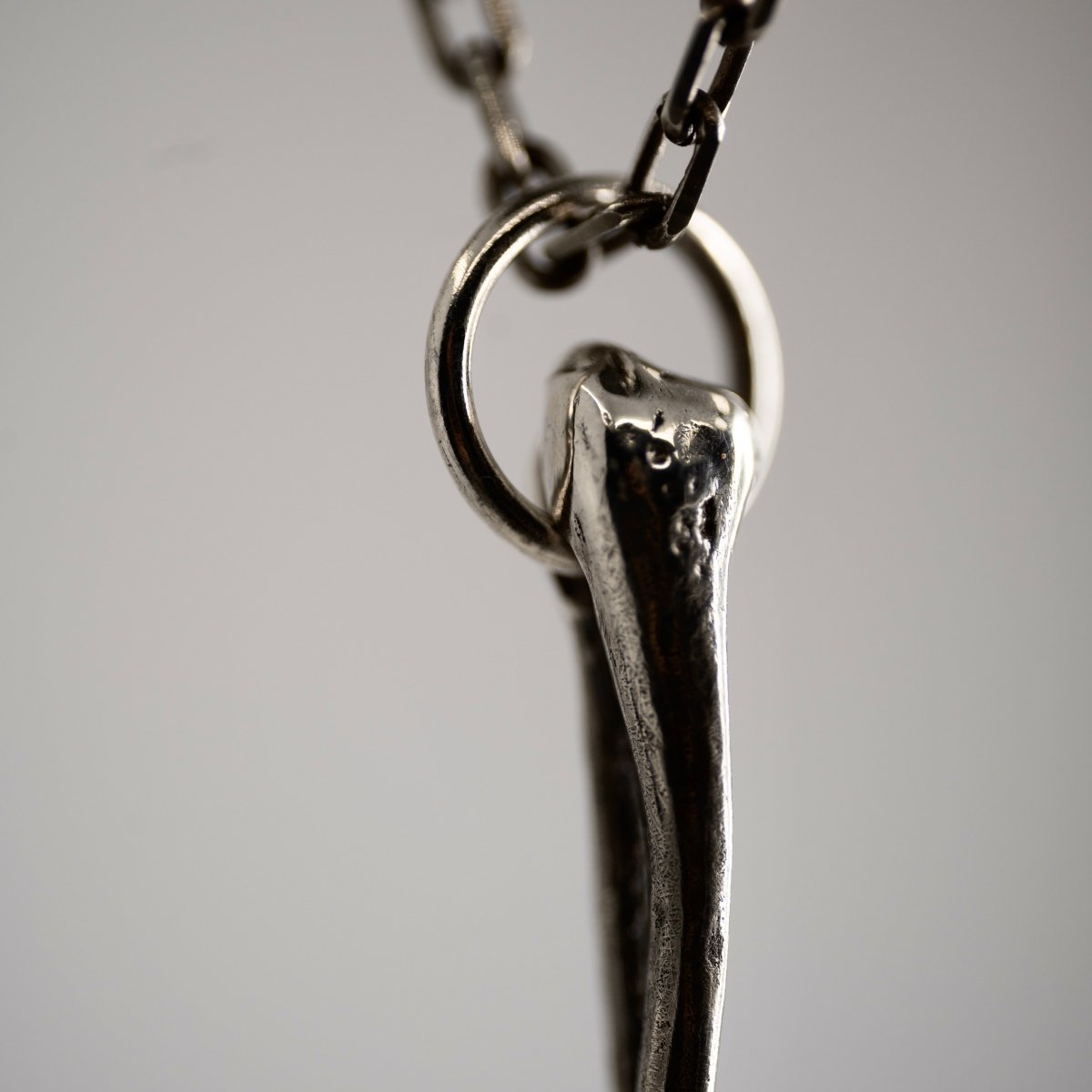 Silver Skeleton Arm pendant shows how pendant connected to the chain 