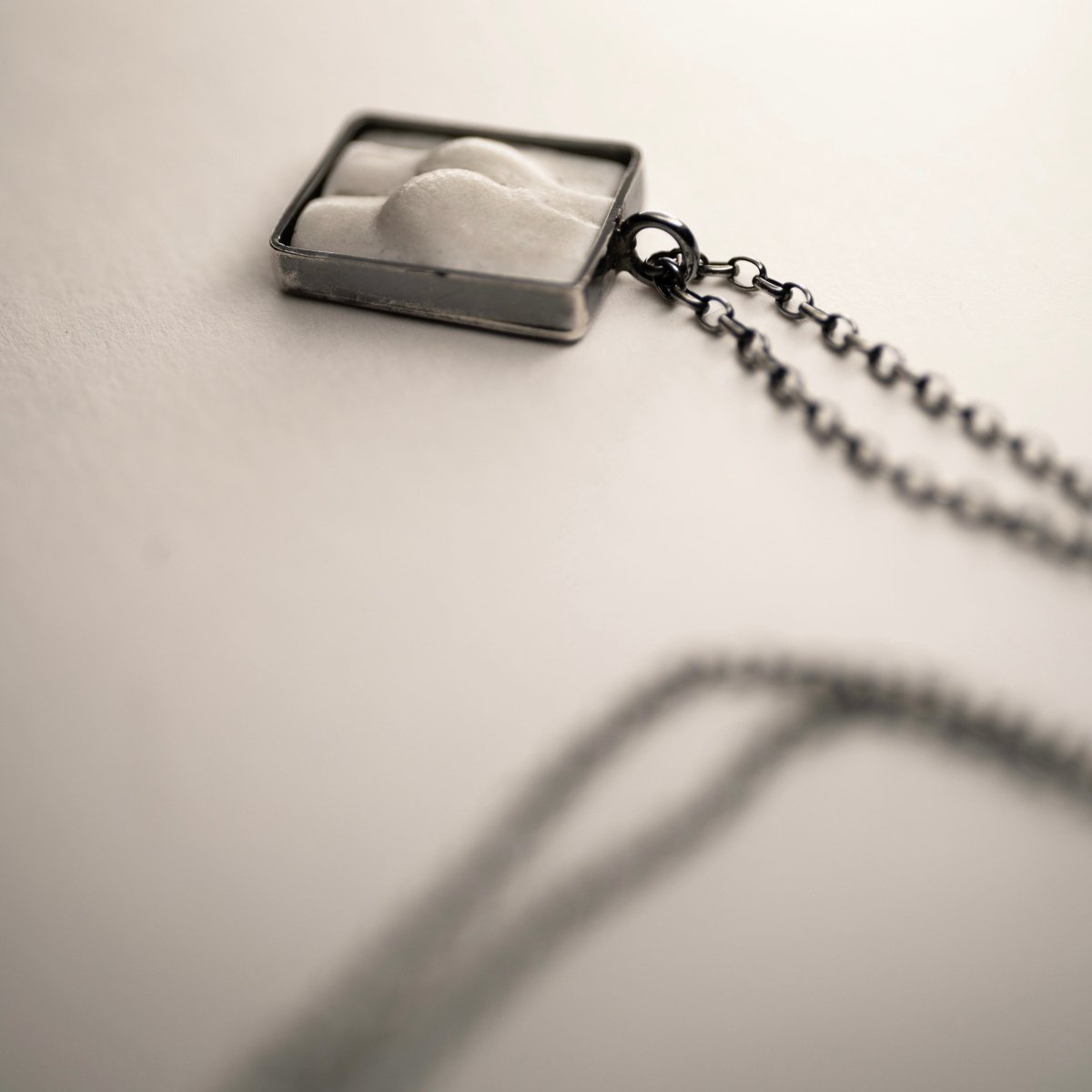Marble Fragment pendant with fixture and chain visible
