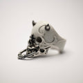 Masked Skull ring - white variant - semi side view, focus on detailed relief on both marble and silver surfaces of the ring