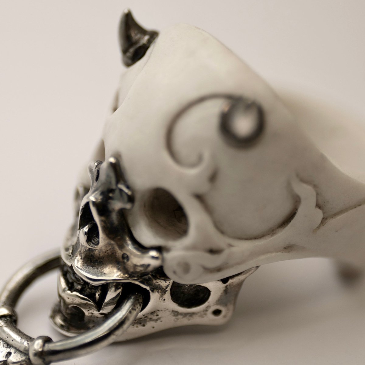Masked Skull ring — white marble variant — close up of ornamental detail on marble skull and sterling silver jaw-mask surface