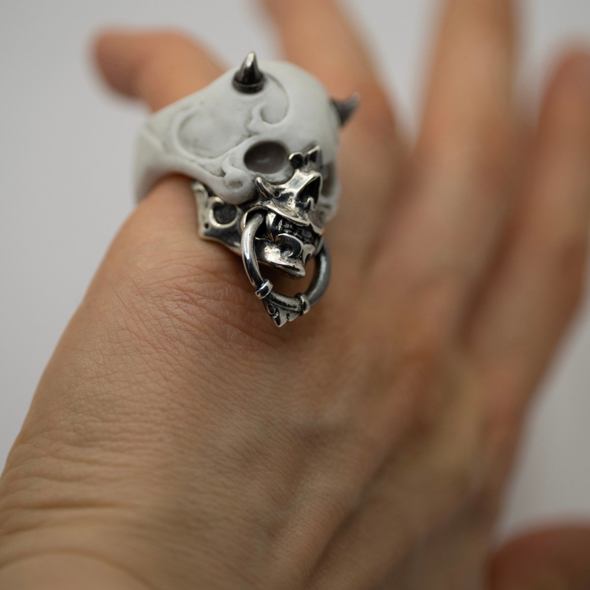 Masked Skull ring — white marble variant — worn on a man's hand, showing scale and proportions