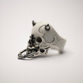 Masked Skull ring — white marble variant — semi-side view showing ornamental relief on marble skull and sterling silver surfaces