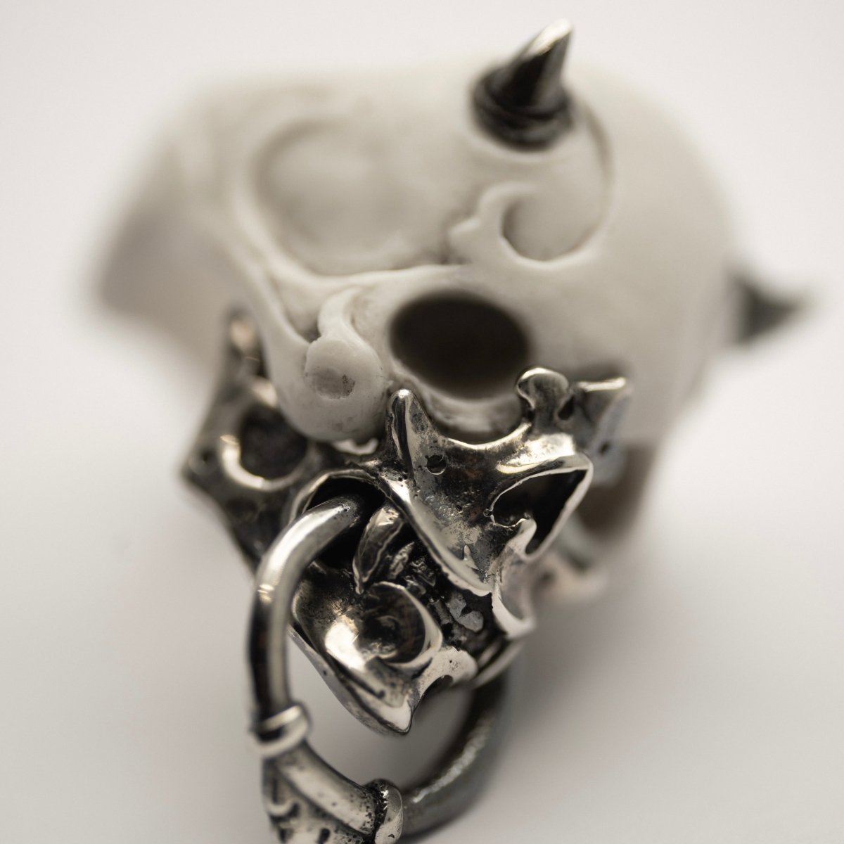 Masked Skull ring — white marble variant — close up of sterling silver jaw-mask with Noh theatre and netsuke-inspired ornamentation