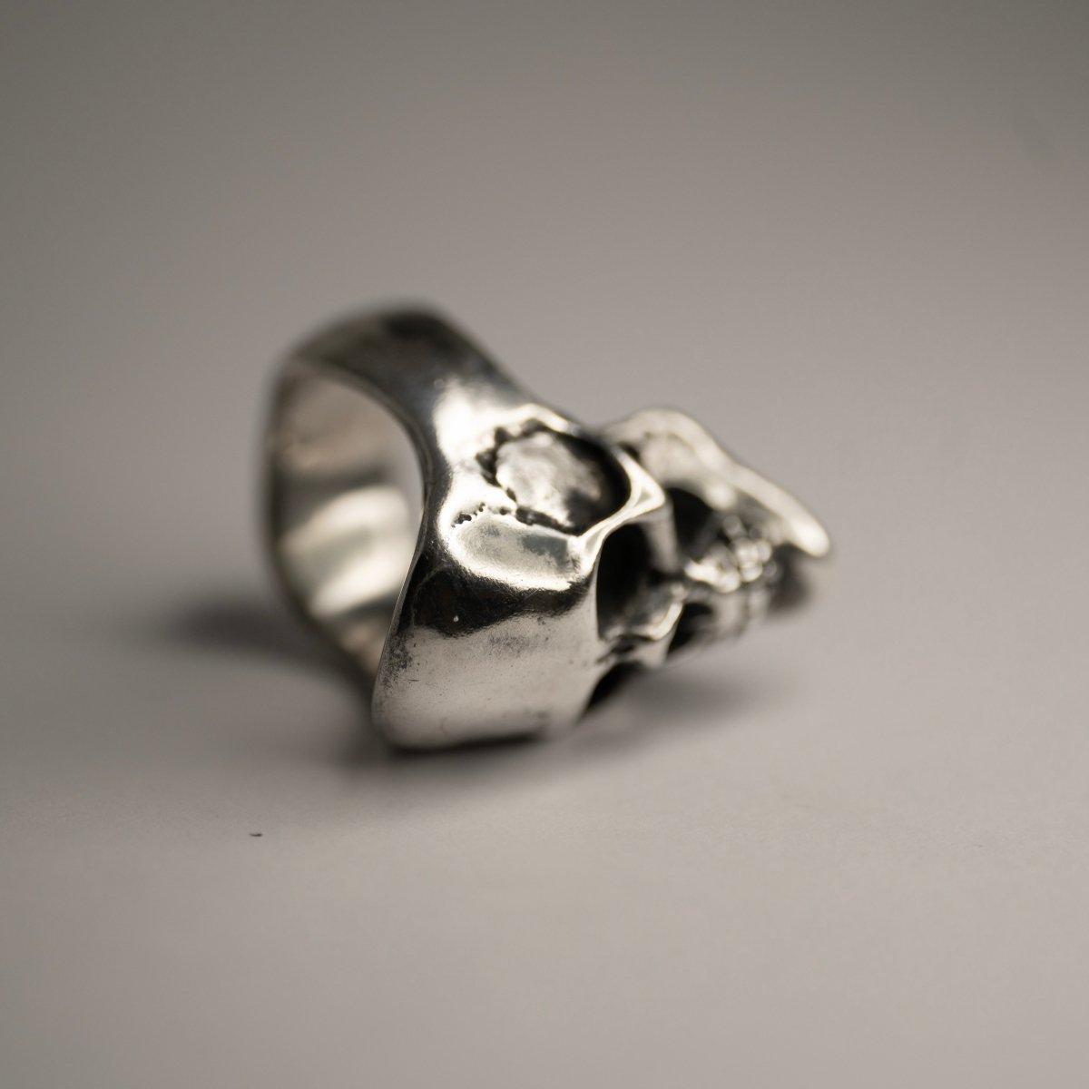 Mercury Silver Skull ring on a white surface