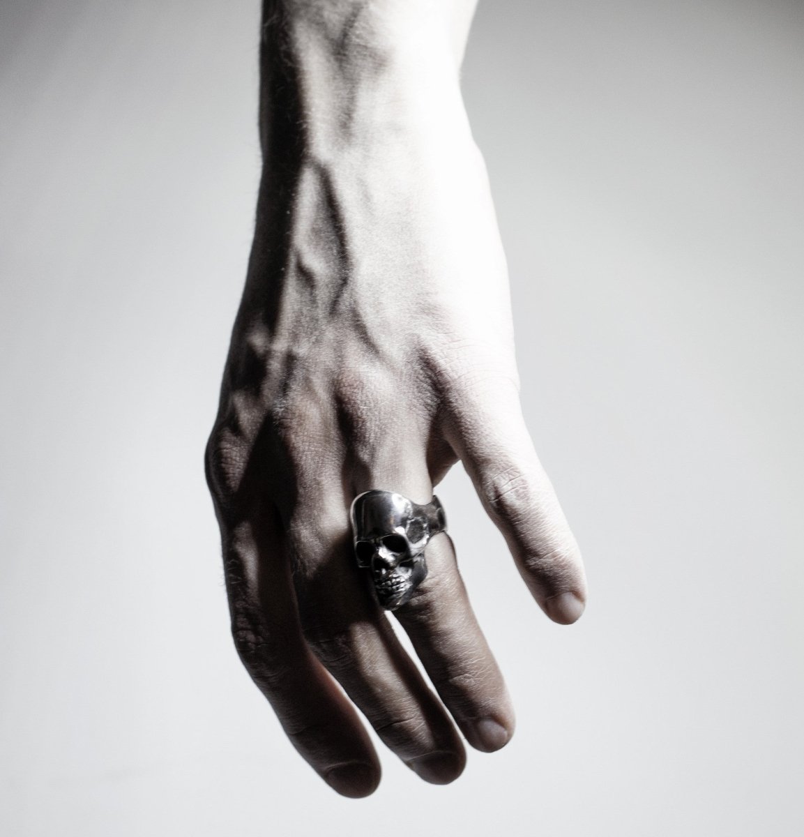 Mercury Silver Skull ring - placed on a hand of a model