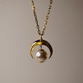 Moon pendant - gold variant - on beige background, front view