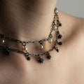 Ancient Pearls necklace and Mosaic necklace by Macabre Gadgets on models neck styled as a stacked necklace