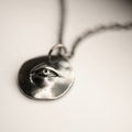 Oculus pendant - gothic eye coin pendant on neutral background
