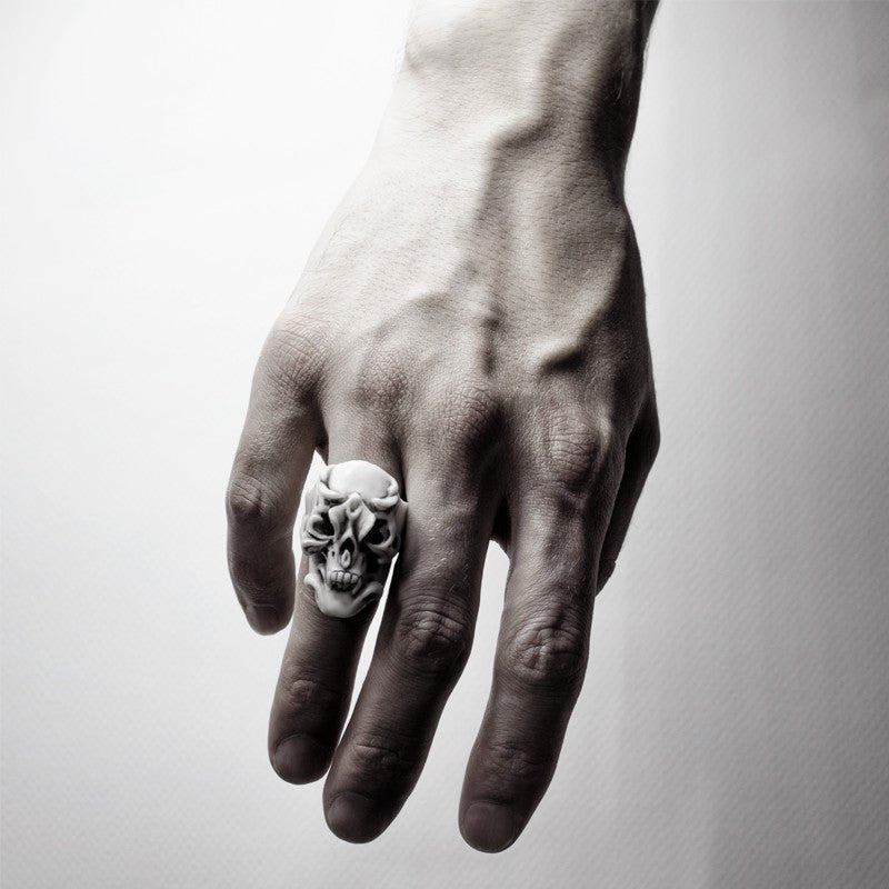Orchid Skull ring, white variant, on a male model's hand