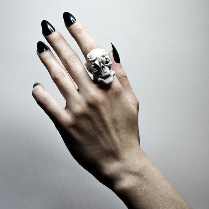 Orchid Skull ring on a female model's hand with polished black nails