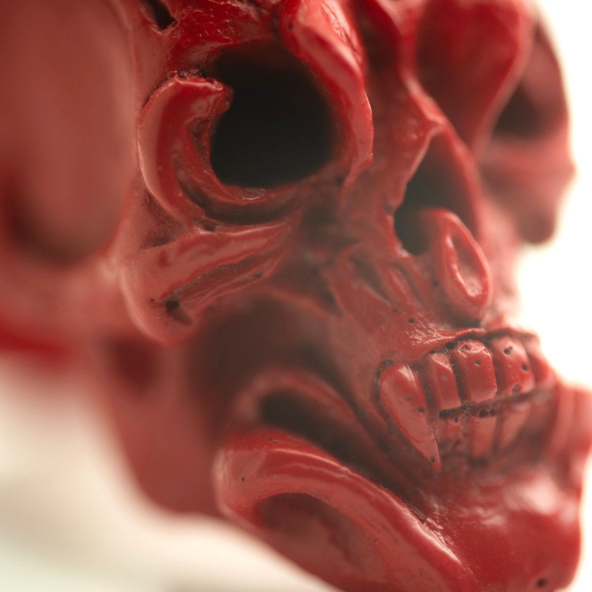 Close-up of skull's decoration, including fangs and orchid details